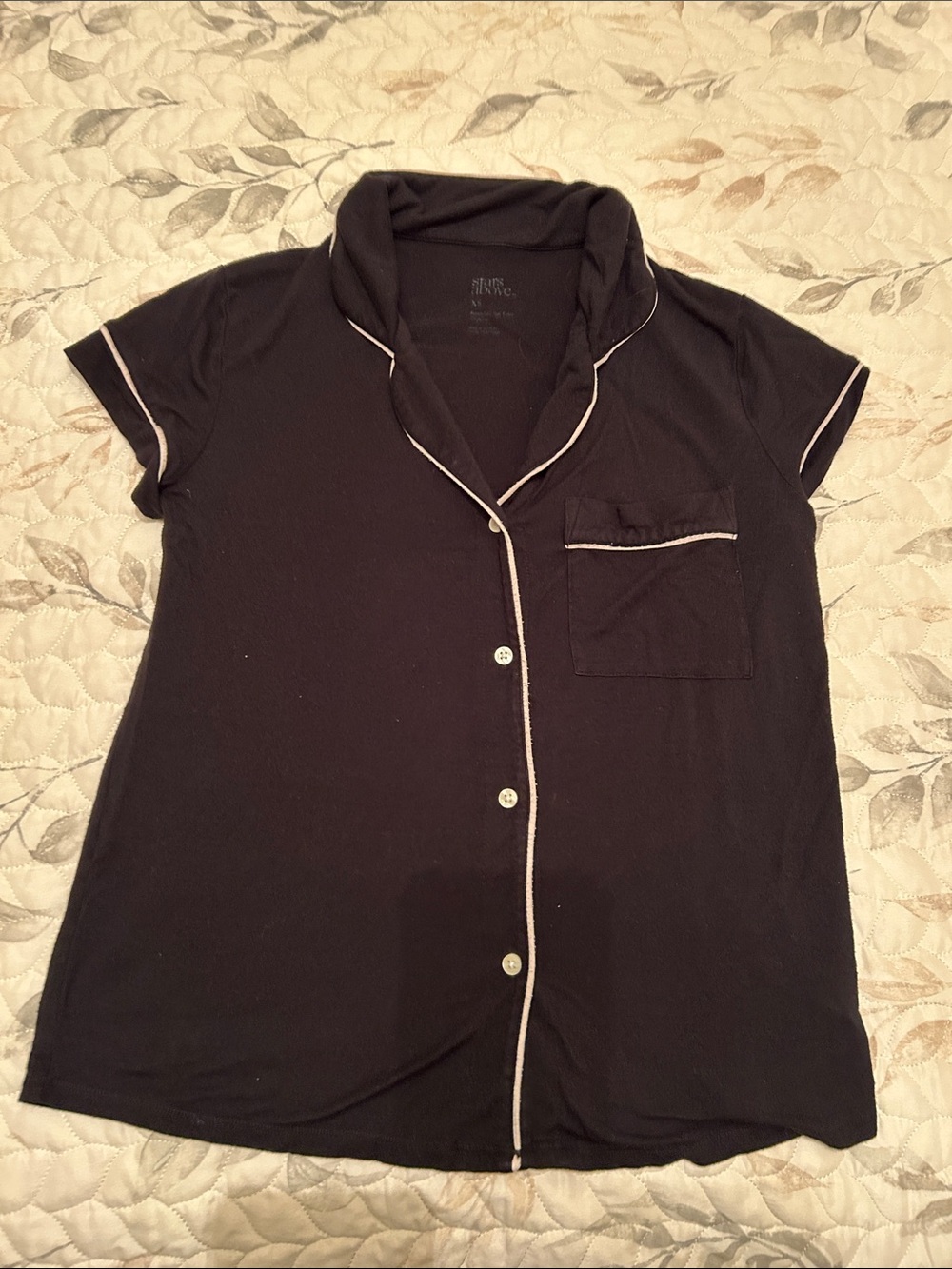 stars above Black Sleep Top with White Label Print